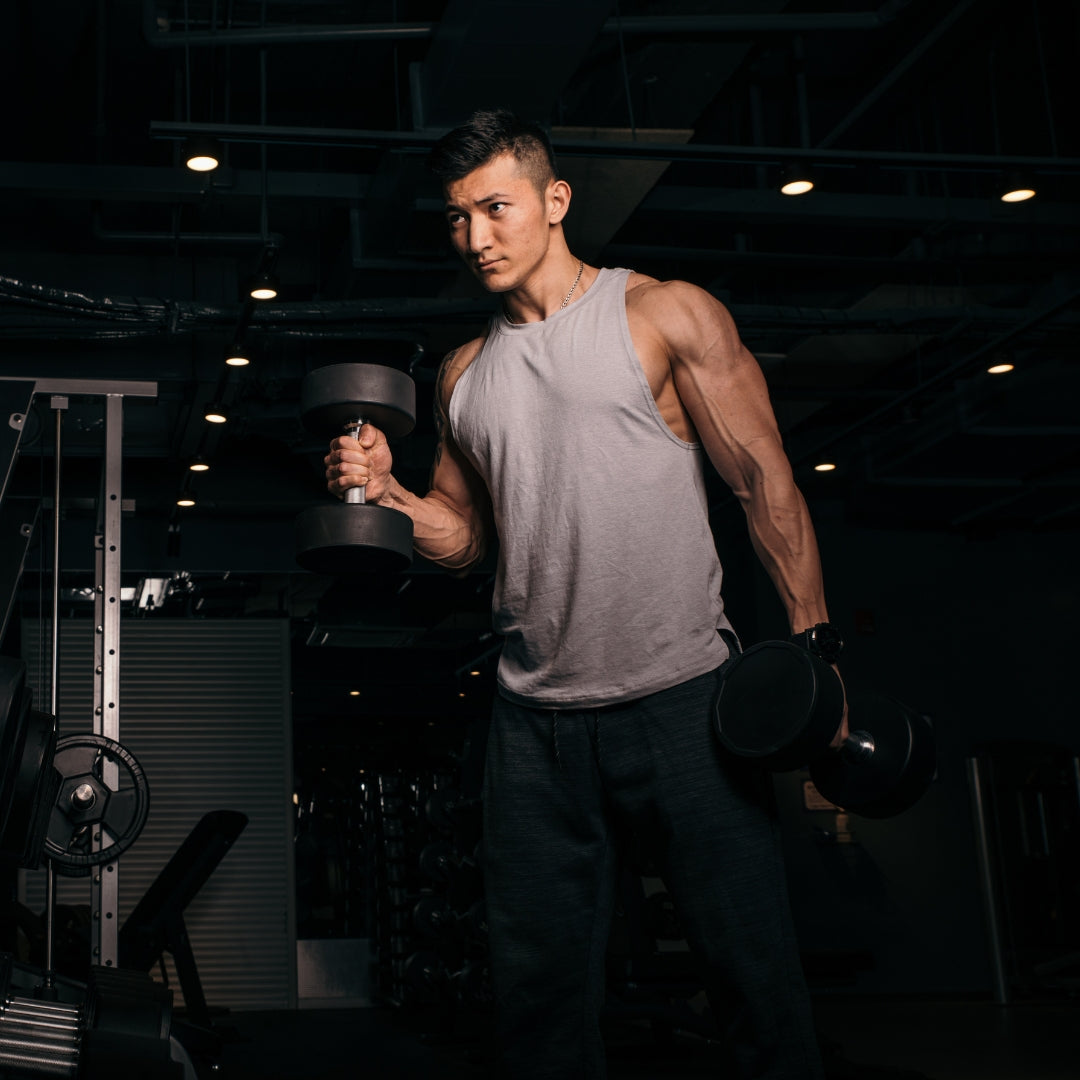 Man holding dumbbells in a gym setting