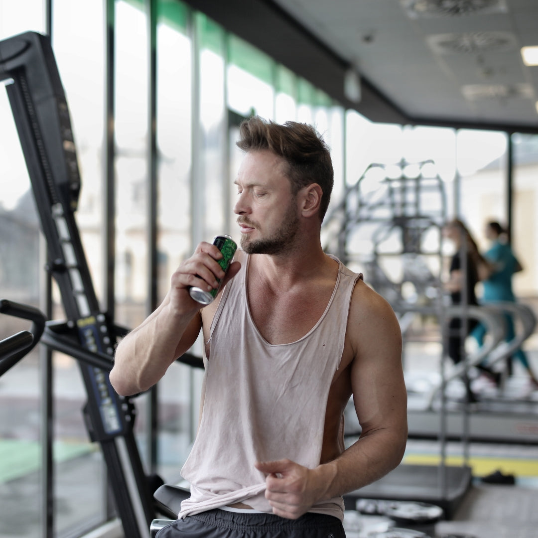 Man in a gym holding a water bottle