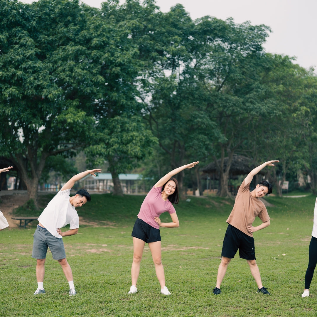 Group of people stretching outdoors in a park